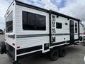 A 2022 Keystone Hideout RDWE 20RDWE travel trailer with a white and black exterior featuring large windows and the word "HIDEOUT" on the side