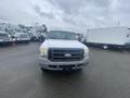 A 2005 Ford F-350 SD with a silver exterior and black grille is positioned prominently in the foreground, showcasing its front view