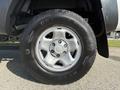 A close-up view of a silver alloy wheel with a Goodyear Wrangler tire mounted on a 2015 Toyota Tacoma