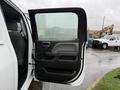 The image shows the open driver's side door of a 2015 GMC Sierra 1500 with a black interior and handle visible