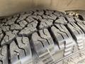 Close-up of a rugged tire with deep tread patterns designed for improved traction and off-road performance on a 2023 Ford Transit