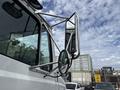 A 1998 Freightliner FL80 truck with chrome side mirrors and a prominent reflective mirror arm