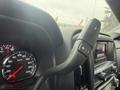 Close-up of the steering column in a 2015 GMC Sierra 1500 showing the speedometer and gear shift lever with controls for manual shifting