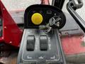 Control panel of a 2012 Toro Groundsmaster featuring a yellow ignition button two toggle switches and a key attached to a ring