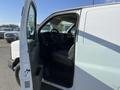 A 2014 Chevrolet Express van with its driver's side door open showing the interior and steering wheel