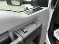 Close-up of the interior door panel of a 2015 Ford F-350 SD featuring window controls and a textured handle