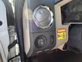 Dashboard controls of a 2014 Ford F-350 SD featuring a dial for temperature settings and a warning label for maximum vehicle height