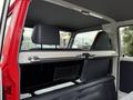 Interior view of a 2001 Toyota Dyna showing the back seat area with a fold-down armrest and storage compartments