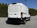 White 2021 Ford Transit 250 van with a high roof and cargo space viewed from the rear