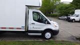 A 2018 Ford Transit with a box truck design parked at an angle showing the driver's side and front features