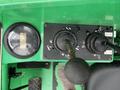 Control panel of a 2014 JLG 10054 featuring several levers and a gauge displaying operational metrics