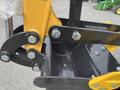 Close-up of a yellow H13R mini excavator attachment showing metal components including bolts and a bucket designed for digging and excavation tasks