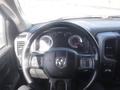 Dashboard view of a 2019 RAM 1500 Classic Eco Diesel featuring a black steering wheel with controls and gauges displaying speed and fuel levels