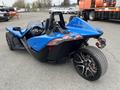 A blue 2020 Polaris Slingshot with an open cockpit and sleek design featuring three wheels and sporty lines