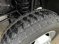 Close-up of a worn tire with visible tread patterns and a silver wheel on a 2012 Ford F-550