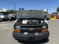 A 2007 Chevrolet Express van with its hood raised showing the engine compartment and front grille featuring a prominent Chevrolet emblem