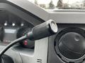 A black microphone attached to the dashboard of a 2013 Ford F-650