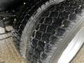 Close-up of two dual rear tires on a 2017 Ford F-550 showing tread patterns and slight water sheen