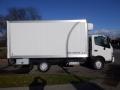 A 2015 Hino 195 truck with a white box cargo area and a gray undercarriage is parked on the street