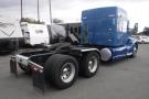 A blue 2015 Kenworth T660 truck with a streamlined design featuring a flatbed and dual rear tires