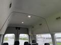 Interior of a 2021 Ford Transit showing the ceiling with lights and vents along with seats visible below