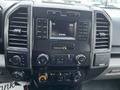 The dashboard and center console of a 2017 Ford F-150 featuring various controls and a display screen