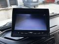 A Hino 338 dashboard display monitor showing a blank screen with control buttons for menu and reversing functions