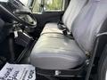 Interior view of a 2014 International TerraStar showing two gray leather seats with seatbelts and a dashboard area
