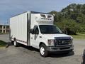 A 2019 Ford Econoline box truck with a white exterior and a refrigerated unit on top parked on a paved surface