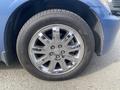 A close-up of a chrome wheel with a stylized multi-spoke design mounted on a tire labeled with the brand Altimax
