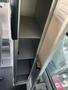 Interior storage compartments in a 2016 Chevrolet Express featuring multiple shelves and a narrow design for organization