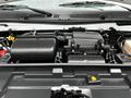 Close-up view of the engine compartment of a 2021 Ford E-450 showing various engine components and air intake system