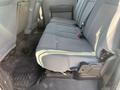 Interior view of a 2015 Ford F-450 SD showing the backseat with gray fabric upholstery and a flat floor mat