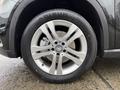 Close-up of a silver alloy wheel on a 2016 Mercedes-Benz GLA-250 featuring a Mercedes logo and a black tire with the brand name visible