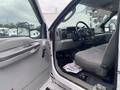 Interior of a 2003 Ford F-450 SD showing the driver's seat steering wheel and dashboard with controls and gear shift visible