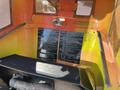 Interior view of a 2010 Kubota F3990 with two black information plates displaying technical specifications and operational guidelines