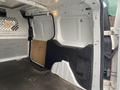 Interior view of a 2017 Ford Transit Connect showing the empty cargo space with a gray floor and wall panels