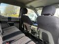 The interior of a 2018 Ford F-150 showing the back seat area with black fabric seats and a center console in between