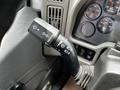 Close-up of a 2019 International 4300's turn signal and wiper control lever featuring labeled functions for lights and wipers