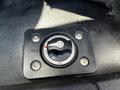 A black ignition switch with labeled positions for on and off, featuring a circular design and a red indicator in the center