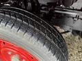 Close-up of a 2001 Toyota Dyna tire with a textured tread pattern mounted on a red rim