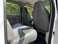 Interior view of a 2009 Ford F-550 focusing on the back seats featuring gray fabric upholstery and a center console between the seats