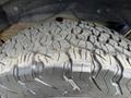 A close-up view of a rugged tire tread from a 2016 Chevrolet Tahoe showcasing deep grooves and textured patterns for off-road performance