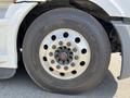 Close-up view of a steel wheel with multiple lug nuts on a 2022 Freightliner Cascadia tire