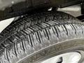 Close-up of a tire with a detailed tread pattern mounted on a wheel of a 2020 Ford Transit