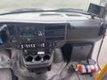 Interior view of a 2016 Chevrolet Express showing the dashboard control panel radio and cup holders