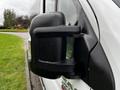 Close-up of the side mirror of a 2016 RAM Promaster with water droplets on the surface