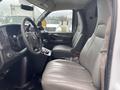 Interior of a 2014 Chevrolet Express showing two front seats and the dashboard with controls and a steering wheel