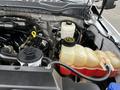 Engine compartment of a 2017 Ford F-550 displaying various components including hoses tanks and a radiator reservoir