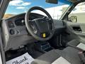 Interior of a 2010 Ford Ranger featuring a steering wheel dashboard and front seats with a focus on the driver's side